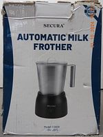 Front view of the product box showing the Secura Automatic Milk Frother model F280R, featuring stainless steel pitcher and black base with handle.
