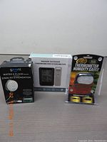 All three devices boxed and visible: Geeni Water and Flood Sensor, Indoor Outdoor Thermometer Hygrometer, and Tom Red Thermometer Humidity Gauge