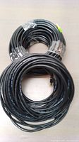 Top view showing two coiled black Ethernet cables secured with tape, one slightly larger in diameter.