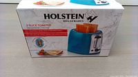 Box of the Holstein 2 slice toaster featuring product image, brand name and product details.