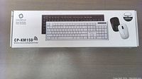 Box showing CoolerPlus CP-KM150 keyboard and mouse combo with image of the white keyboard and mouse on front