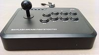 Front and top angle view of the black Mayflash Arcade Fightstick F101 showing joystick and eight buttons with cables at the back.