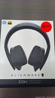 Front view of Alienware 310H stereo gaming headset box showing the headset image, Alienware branding, and 310H model.