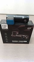 OMBAR WDR 2K dash cam displayed on top of the retail box showing compact cylindrical camera and lens details.
