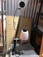 Vivitar E74 enlarger unit with arm, bulb housing, power cord, and metal base shown in storage setting