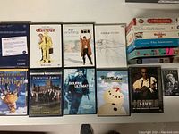 Top-down view of DVDs and VHS tapes front covers showing titles and cover art.