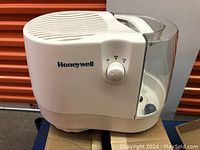 White Honeywell humidifier with control knob and water tank.
