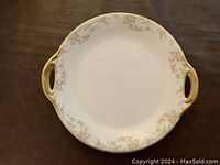 Top view of the Limoges porcelain platter showing floral decoration and gold trim with side handles.