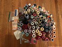 Large variety of thread spools in multiple colors and types along with some pins and fasteners in original packaging