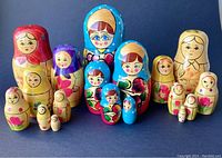 Photo of all three doll sets displayed together showing size and color differences.