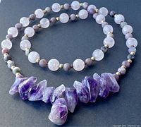 Front and side views of the purple and pink amethyst and lepidolite beaded necklace with rough amethyst stone centerpiece.