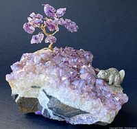 Front angle showing wire tree with amethyst leaves on the natural crystal cluster, with beaver figurine on right side