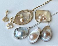 Overview of all blister pearl jewelry including pendants and earrings on a white background