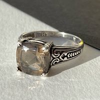 Close-up view of the ring showing the smokey quartz stone and detailed silver engraving along the band's side.