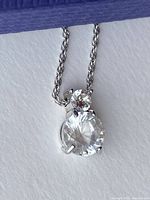 Close-up of the pendant showing the two brilliant cut crystals and part of the chain.