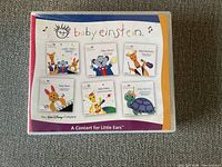 Front cover of the Baby Einstein CD set box titled A Concert for Little Ears showing six illustrated CDs with animal characters and titles.