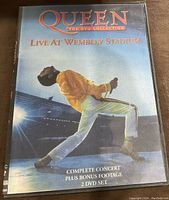 Front cover of Queen Live At Wembley Stadium DVD showing Freddie Mercury performing on stage.