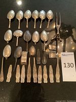Top-down view of all flatware components arranged on black surface