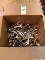 Box filled with mixed cutlery and piggy bank piece