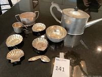 Overview showing all items: coffee pot, round bowl, sugar basket, creamer, six shell dishes, double divided dish