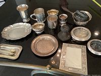 Overhead view of all silver pieces on black surface