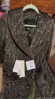 Full view of Terry Lewis crushed velour green ladies coat with tags attached, showing front collar and overall texture.