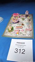 Miniature Easter-themed set displayed on small decorative rug showing basket, bunny figurines, candy eggs, Peeps, greeting cards, and more