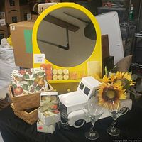 Yellow wood Ikea hanging mirror shelf with round mirror and coat rack, surrounded by fall decor items including votive candles, paper napkins, sunflower decor, wood baskets, and glass martini glasses