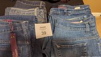 Six pairs of Gloria Vanderbilt Amanda jeans, size 10, assorted washes, one pair with original tags visible.