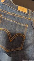 Back pocket detail on dark wash Levi's jeans showing classic Levi's stitching and leather patch.