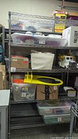 Full view of metal wire shelving unit loaded with various plastic containers and boxes (not included in sale)