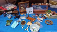 Lot overview showing miniature jewelry counter, bakery display, cutting counter, and scattered accessories including flowers and jewelry pieces on blue cloth