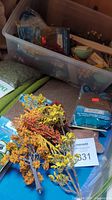 Photo showing assortment of miniature fall color trees and bags of ground cover materials including moss and grit.