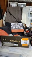 Simms Freestone Stockingfoot waders in original box, showing box label and product image.