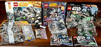 All three Lego Star Wars sets in original boxes with multiple sealed and loose bags of pieces, plus Darth Vader keychain
