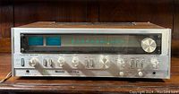 Front view of vintage Nikko NR-1015 stereo receiver showing analog tuning dial, power and tuning meters, and control knobs.