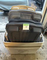 Five stacked large plastic storage bins with six lids in various colors, one bin labeled 'Christmas Decorations'