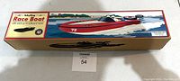 Box of Schylling Race Boat toy featuring colorful illustration of boat on water with text and logo.