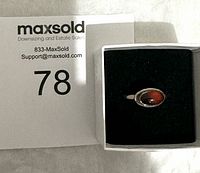 Sterling silver amber ring in ring box with MaxSold tag number 78.