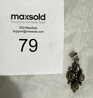 Full view of sterling silver labradorite pendant next to a lot number display card.