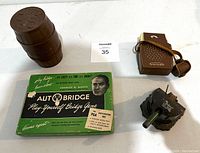 Vintage games and toys including Autobridge boxed game, barrel of monkeys stacked, toy cap cannon, and brown Supreme transistor radio