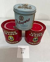 Photo showing the three vintage tobacco tins stacked with the Player's tin on top of two Union Leader tins, all with lids present.