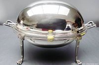 Frontal view of silverplate warmer with dome lid closed, ivory knob, curved handles, paw feet