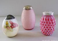 Photo of all three vintage glass sugar shakers with metal lids, showing colors and shapes
