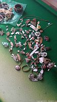 Overhead shot of assorted costume jewelry on green surface