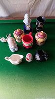 Top view of nine assorted ceramic and decorative figurines and containers