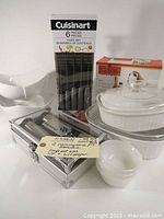 Mixed kitchenware lot showing Cuisinart knife set, salt and pepper mills, salad crisper, and dessert bowls.