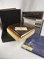 Group of six assorted scrapbooks and photo albums, showing various colors, textures, and decorative elements