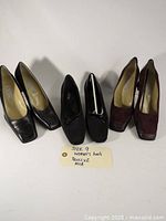Three pairs of women's heels size 9: two black leather Bocci pairs, one burgundy suede Alia pair arranged side by side.