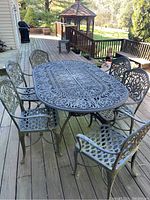 Full set of one table and six chairs on wooden deck